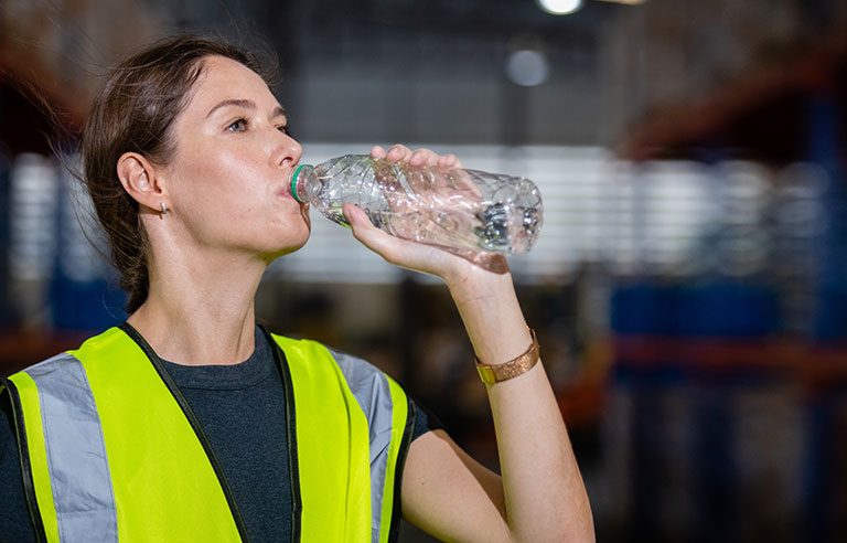 Construction workers drinking water on an active jobsite