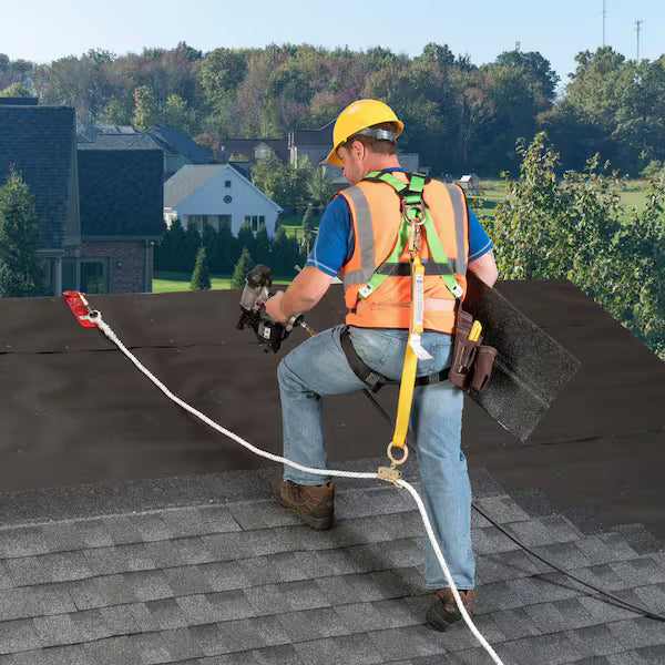 Construction worker wearing full body fall protection harness